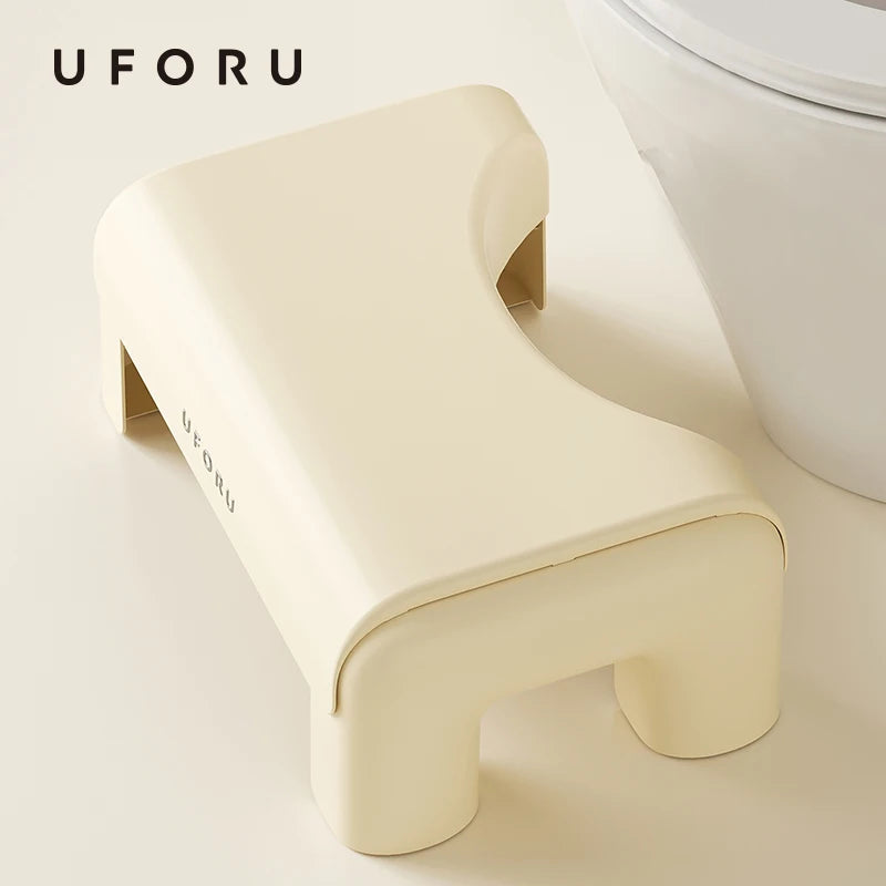 Beige toilet step stool with 'UFORU' branding next to a toilet in a bathroom setting.