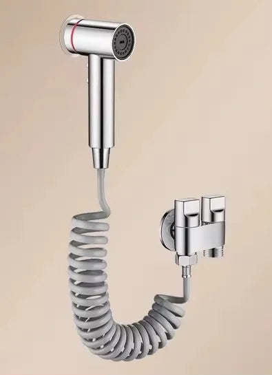 Chrome bathroom faucet set with spiral hose on beige background