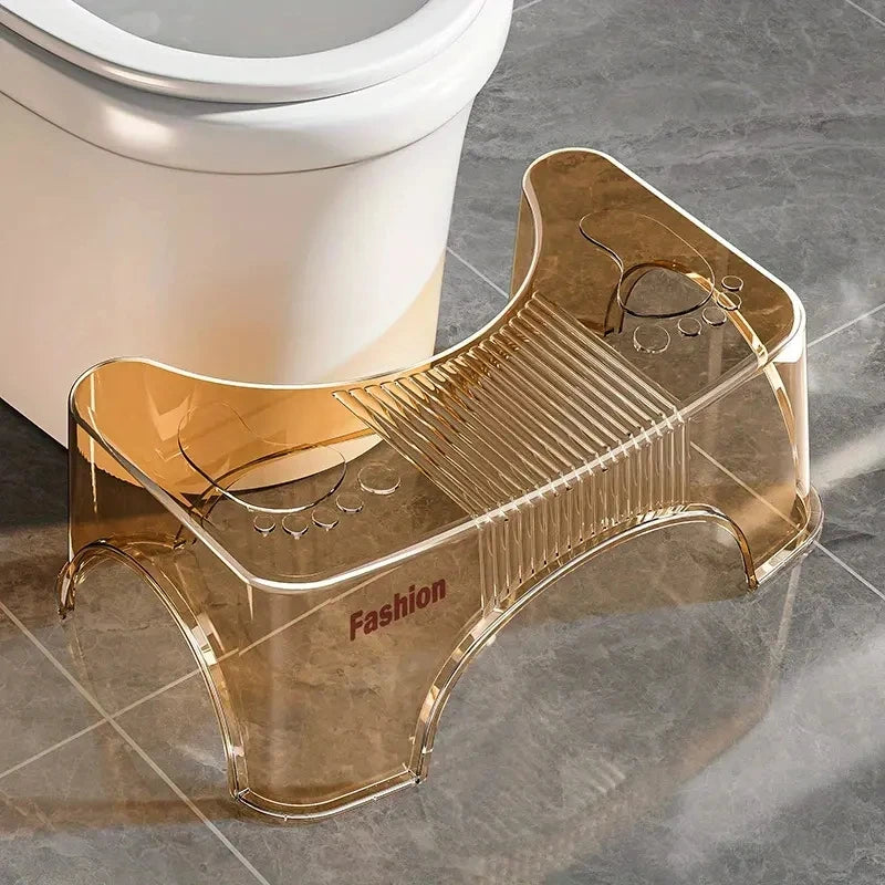 Gold toilet stool with 'Fashion' branding next to a toilet on a tiled floor.