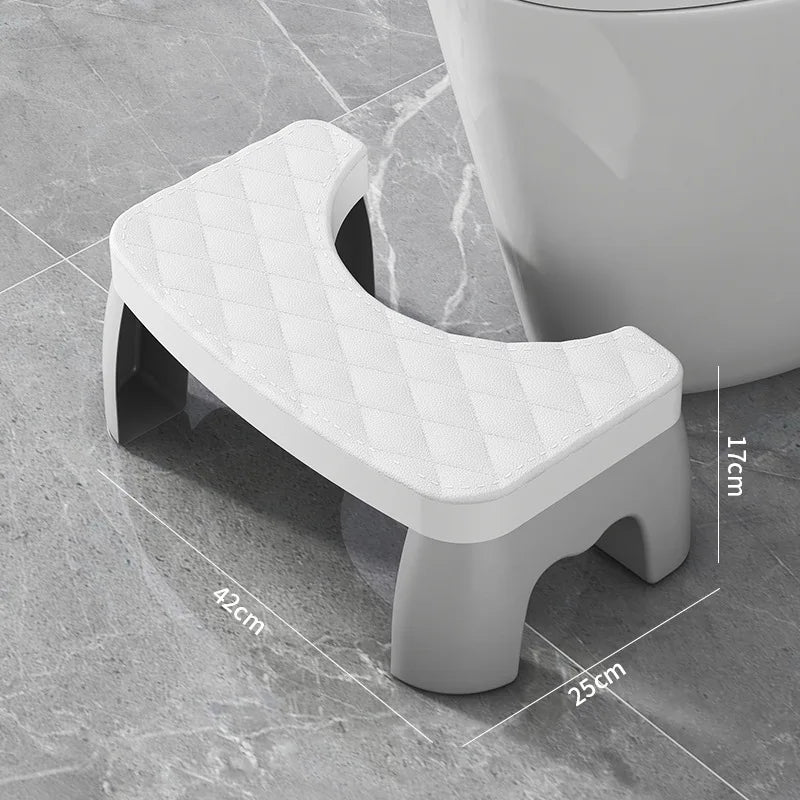 Gray toilet stool on a tiled bathroom floor with dimensions indicated.