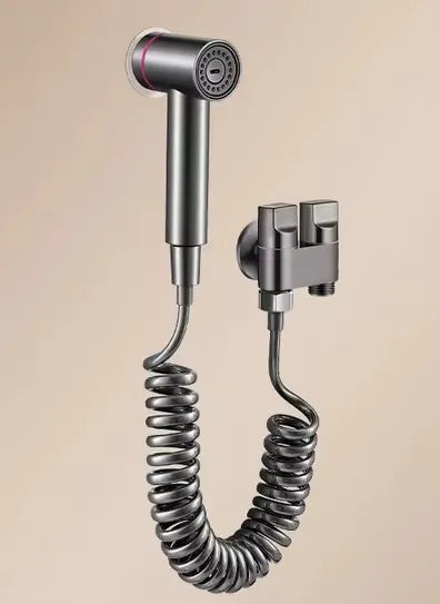 Shower head with flexible hose and valve components on a beige background